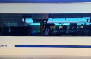 A self-photograph of Karthikeyan KC from the reflection on the windows of the Vande Bharat Express train.